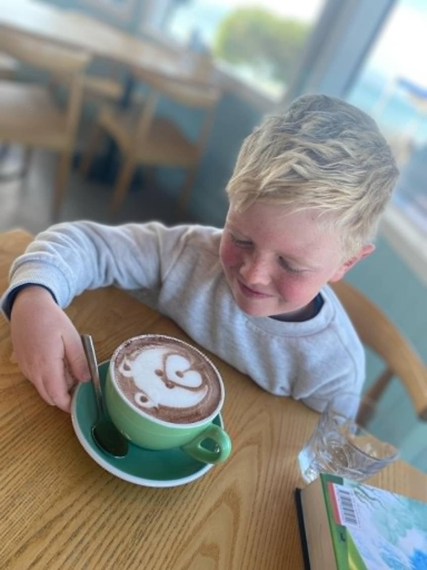Harvey enjoying a hot chocolate at a cafe